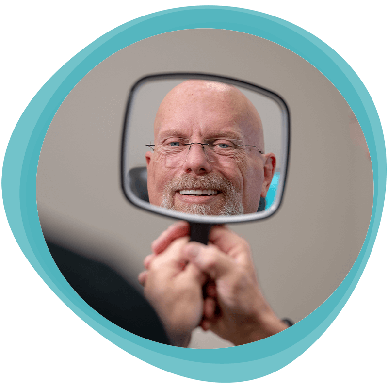steve viewing new smile with mirror